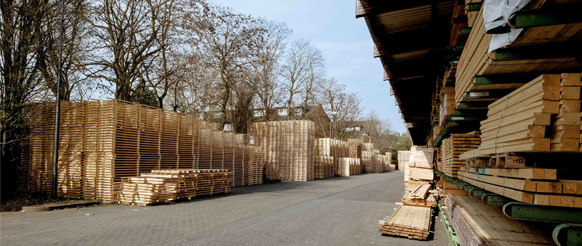 View of an access road between warehouse buildings with roller doors.